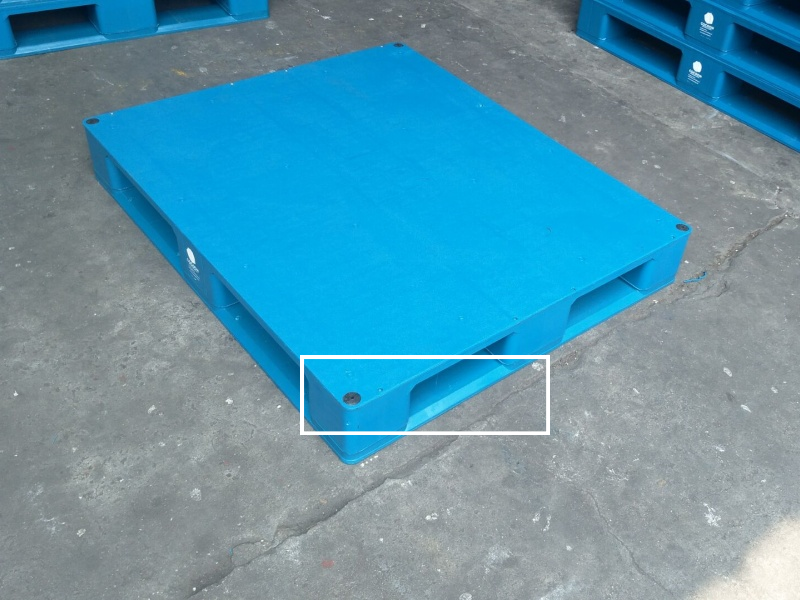 Injection-molded 6 runners plastic pallet with sloped four-way forklift entry designed for smooth loading dock operations.
